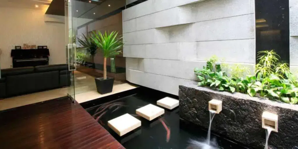A modern living room with a water feature.