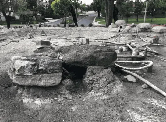 An old black and white photo of a construction site with leaking pond tips.