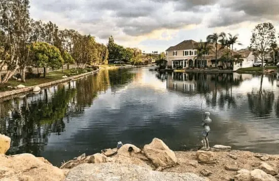 A waterway with houses in an HOA community.