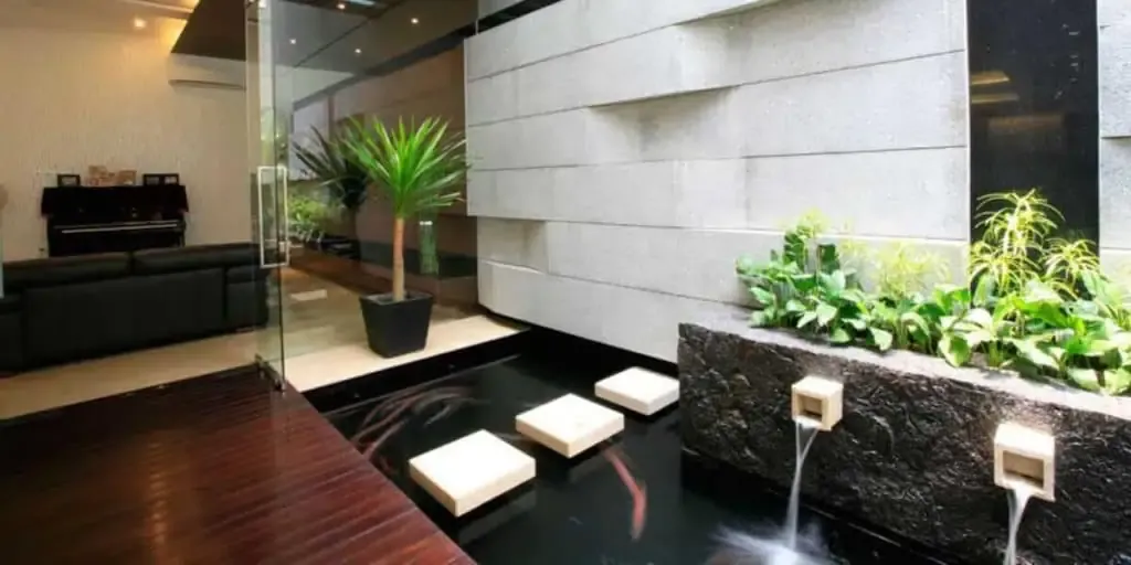 A modern living room with a water feature.
