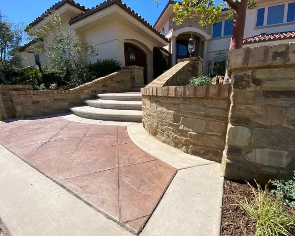 A driveway with stone steps leading to a home.