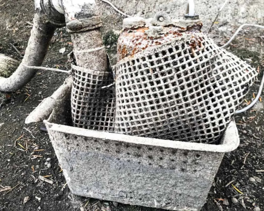 A metal basket with a pipe in it.