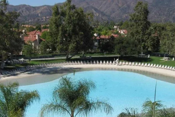 A swimming pool with a mountain in the background.